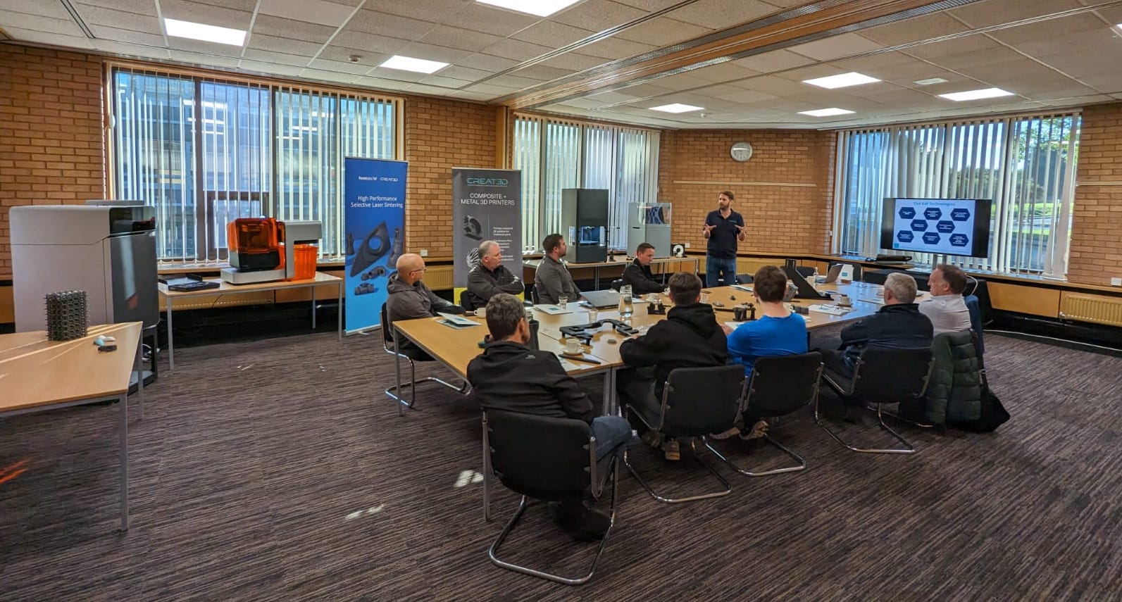 Workshop in session with printers and people engaged in learning